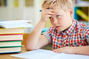 Attentive schoolboy sitting at lesson